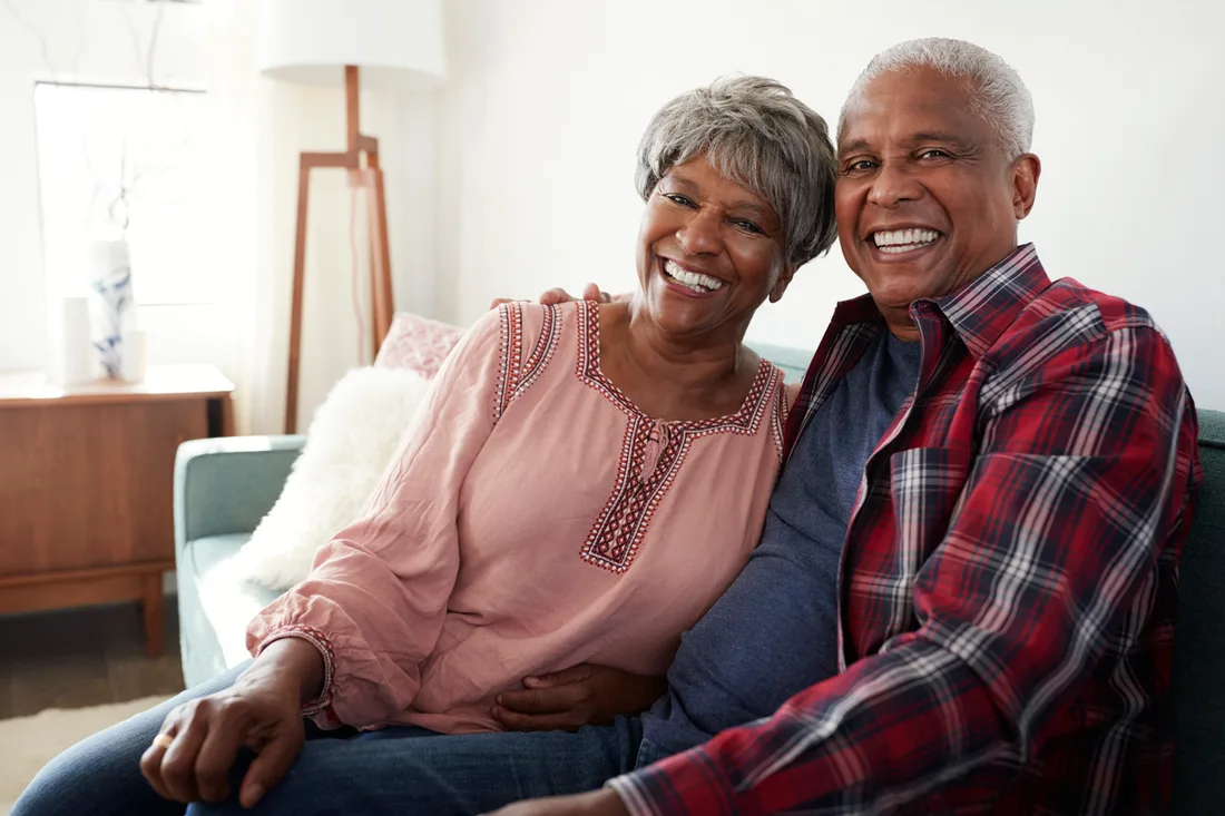 Senior Black couple smiling together at home