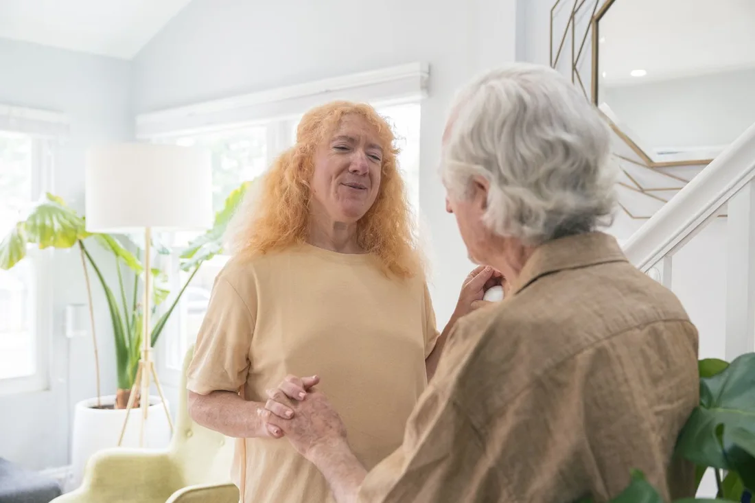 Senior couple holding hands and smiling together